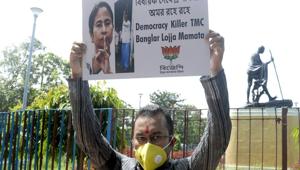 BJP party supporter holds a placard as he participates in a protest against the death of party MLA Debendra Nath Ray who was found hanging in Bindal, at Hemtabad in Kolkata.(ANI) BJP party supporter holds a placard as he participates in a protest against the death of party MLA Debendra Nath Ray who was found hanging in Bindal, at Hemtabad in Kolkata.(ANI)