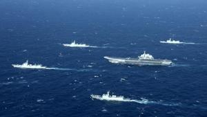 This aerial file photo shows a Chinese Navy formation, including the aircraft carrier Liaoning (C), during military drills in the South China Sea. -(AFP File)