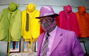 Kenyan fashionista James Maina Mwangi poses for a photograph as he displays his attire comprising at least 160 suits with matching accessories including a mask to prevent the coronavirus disease (COVID-19) infection at his residence in Nairobi, Kenya July 30, 2020. Picture taken July 30, 2020.(REUTERS) Kenyan fashionista James Maina Mwangi poses for a photograph as he displays his attire comprising at least 160 suits with matching accessories including a mask to prevent the coronavirus disease (COVID-19) infection at his residence in Nairobi, Kenya July 30, 2020. Picture taken July 30, 2020.(REUTERS)