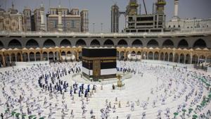 Limited numbers of pilgrims, move several feet apart, circling the cube-shaped Kaaba in the first rituals of the hajj, as they keep social distancing to help prevent the spread of the coronavirus, in the Muslim holy city of Mecca, Saudi Arabia.(AP) Limited numbers of pilgrims, move several feet apart, circling the cube-shaped Kaaba in the first rituals of the hajj, as they keep social distancing to help prevent the spread of the coronavirus, in the Muslim holy city of Mecca, Saudi Arabia.(AP)