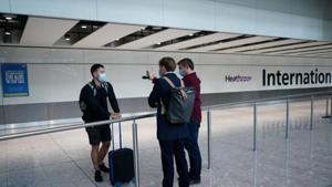 Reporters speak to a traveller arriving from Madrid at the Terminal 5 at Heathrow Airport, as the spread of the coronavirus disease (COVID-19) continues, in London.(REUTERS) Reporters speak to a traveller arriving from Madrid at the Terminal 5 at Heathrow Airport, as the spread of the coronavirus disease (COVID-19) continues, in London.(REUTERS)