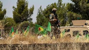 A member of security of the Syrian Democratic Forces (SDF) stands guard as Syrian Kurdish women demonstrate in front of a US base in the countryside of the Hasakeh province.(AFP file photo) A member of security of the Syrian Democratic Forces (SDF) stands guard as Syrian Kurdish women demonstrate in front of a US base in the countryside of the Hasakeh province.(AFP file photo)