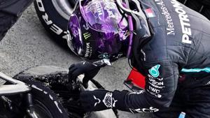 Mercedes' Lewis Hamilton looks at his tyre after winning the race with a puncture on the final lap.(Pool via REUTERS) Mercedes' Lewis Hamilton looks at his tyre after winning the race with a puncture on the final lap.(Pool via REUTERS)