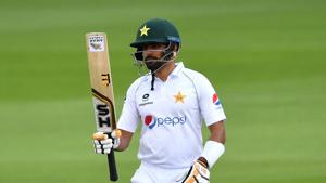 Pakistan's Babar Azam reaches 50 runs during the first day of the first Test cricket match between England and Pakistan at Old Trafford in Manchester.(AFP)