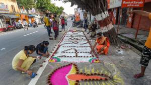 Children and youngsters make ‘rangoli’ on pavement along a road, on the eve of the groundbreaking ceremony of the Ram Mandir, in Ayodhya.(PTI) Children and youngsters make ‘rangoli’ on pavement along a road, on the eve of the groundbreaking ceremony of the Ram Mandir, in Ayodhya.(PTI)