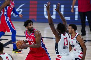 Philadelphia 76ers center Joel Embiid (21) looks to shoot over Washington Wizards center Thomas Bryant (13) during the second half of an NBA basketball game Wednesday.(AP) Philadelphia 76ers center Joel Embiid (21) looks to shoot over Washington Wizards center Thomas Bryant (13) during the second half of an NBA basketball game Wednesday.(AP)