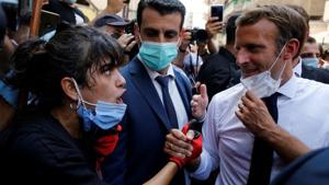 French President Emmanuel Macron listens to a resident as he visits a devastated street of Beirut, Lebanon August 6, 2020.(Reuters photo) French President Emmanuel Macron listens to a resident as he visits a devastated street of Beirut, Lebanon August 6, 2020.(Reuters photo)