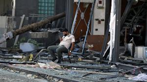 Security personnel sit in front of damaged buildings near the site of an explosion on Tuesday that hit the seaport of Beirut, Lebanon, Thursday, Aug. 6, 2020.(AP photo) Security personnel sit in front of damaged buildings near the site of an explosion on Tuesday that hit the seaport of Beirut, Lebanon, Thursday, Aug. 6, 2020.(AP photo)