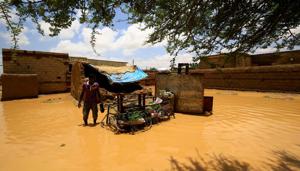 A Sudanese man stands next to the belongings of a house, after torrential rain lead to landslides and flash floods, in the town of Umm Dawan Ban, southeast of the capital Khartoum on August 2, 2020.(AFP photo) A Sudanese man stands next to the belongings of a house, after torrential rain lead to landslides and flash floods, in the town of Umm Dawan Ban, southeast of the capital Khartoum on August 2, 2020.(AFP photo)