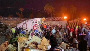 Rescue operations underway after an Air India Express flight with 190 passengers on board enroute from Dubai skidded off the runway while landing, at Karipur airport in Kozhikode on Friday.(PTI PHOTO.) Rescue operations underway after an Air India Express flight with 190 passengers on board enroute from Dubai skidded off the runway while landing, at Karipur airport in Kozhikode on Friday.(PTI PHOTO.)