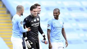 Manchester City's goalkeeper Ederson is congratulated by team mates after winning the Premier League Golden Glove after the English Premier League soccer match between Manchester City and Norwich City at the Etihad Stadium.(AP) Manchester City's goalkeeper Ederson is congratulated by team mates after winning the Premier League Golden Glove after the English Premier League soccer match between Manchester City and Norwich City at the Etihad Stadium.(AP)
