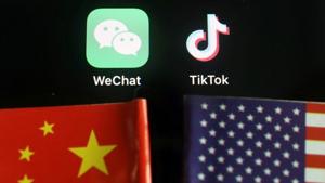 The messenger app WeChat and short-video app TikTok are seen near China and US flags.(REUTERS) The messenger app WeChat and short-video app TikTok are seen near China and US flags.(REUTERS)