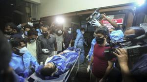 One of the persons injured after an Air India Express flight skidded off a runway while landing at the Kozhikode airport is brought for treatment to the Medical College Hospital in Kozhikode, Kerala.(AP) One of the persons injured after an Air India Express flight skidded off a runway while landing at the Kozhikode airport is brought for treatment to the Medical College Hospital in Kozhikode, Kerala.(AP)