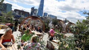 People eat outside and inside private dining pods, on the terrace of a restaurant, in London, Britain, August 6, 2020.(REUTERS) People eat outside and inside private dining pods, on the terrace of a restaurant, in London, Britain, August 6, 2020.(REUTERS)