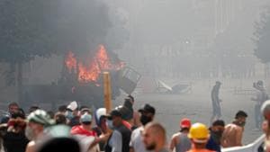 A vehicle burns as demonstrators try to break through a barrier to get to the parliament building during a protest following Tuesday's blast, in Beirut, Lebanon.(REUTERS) A vehicle burns as demonstrators try to break through a barrier to get to the parliament building during a protest following Tuesday's blast, in Beirut, Lebanon.(REUTERS)