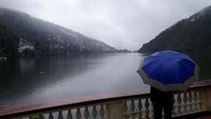 A local walking by Naini Lake in Nainital district on Sunday amid heavy rain.(Raajiv Kala/HT Photo for representative purpose) A local walking by Naini Lake in Nainital district on Sunday amid heavy rain.(Raajiv Kala/HT Photo for representative purpose)