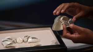 Isaac Levy, owner of Israeli jewelry company Yvel holds parts of a mask in Motza near Jerusalem.(AP) Isaac Levy, owner of Israeli jewelry company Yvel holds parts of a mask in Motza near Jerusalem.(AP)