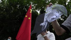 Pro-China supporters display a picture of US President Donald Trump during a protest against the US sanctions outside the US Consulate in Hong Kong.(AP) Pro-China supporters display a picture of US President Donald Trump during a protest against the US sanctions outside the US Consulate in Hong Kong.(AP)