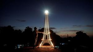 Jorge Enrique Salgado poses for a photo beside a replica of the Eiffel Tower he built on the roof of his home in Havana, Cuba, August 7, 2020.(REUTERS/Alexandre Meneghini) Jorge Enrique Salgado poses for a photo beside a replica of the Eiffel Tower he built on the roof of his home in Havana, Cuba, August 7, 2020.(REUTERS/Alexandre Meneghini)