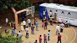 People stand in a queue to test for Covid-19 near a mobile swab collection vehicle, at Indira Gandhi Municipal Corporation Stadium, in Vijayawada.(ANI Photo) People stand in a queue to test for Covid-19 near a mobile swab collection vehicle, at Indira Gandhi Municipal Corporation Stadium, in Vijayawada.(ANI Photo)