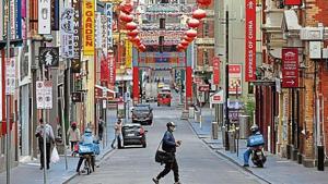 A man crosses a quiet road in Melbourne’s Chinatown area on Thursday.(AFP) A man crosses a quiet road in Melbourne’s Chinatown area on Thursday.(AFP)