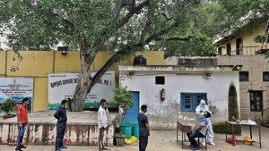 People wait for their swab samples to be collected at a testing centre in Daryaganj. People wait for their swab samples to be collected at a testing centre in Daryaganj.