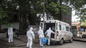 Contract workers in PPE equipment seen sanitizing the ambulance after transporting the body of a coronavirus victim, at Yerwada crematorium, in Pune.(Pratham Gokhale/HT Photo) Contract workers in PPE equipment seen sanitizing the ambulance after transporting the body of a coronavirus victim, at Yerwada crematorium, in Pune.(Pratham Gokhale/HT Photo)