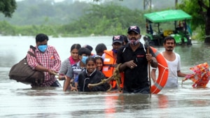 Rescuers lead a group of people to safety in Warrangal in Telangana.(Sourced) Rescuers lead a group of people to safety in Warrangal in Telangana.(Sourced)