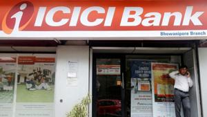 A man speaks on the phone outside an ICICI Bank branch in Kolkata, India.(REUTERS) A man speaks on the phone outside an ICICI Bank branch in Kolkata, India.(REUTERS)