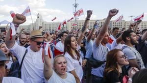 People with old Belarusian national flags shout during opposition rally in front of the government building of Minsk, Belarus on Sunday.(AP Photo)