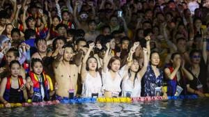 This photo taken on August 15, 2020 shows people watching a performance as they cool off in a swimming pool in Wuhan in China's central Hubei province.(AFP) This photo taken on August 15, 2020 shows people watching a performance as they cool off in a swimming pool in Wuhan in China's central Hubei province.(AFP)