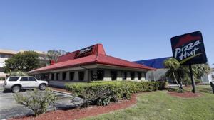 Pizza Hut has reached an agreement with one of its largest franchisees to close 300 underperforming US restaurants.(AP Photo) Pizza Hut has reached an agreement with one of its largest franchisees to close 300 underperforming US restaurants.(AP Photo)