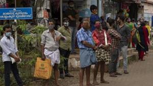 People wearing masks as a precaution against the coronavirus disease wait for transportation in Kochi, Kerala.(AP Photo) People wearing masks as a precaution against the coronavirus disease wait for transportation in Kochi, Kerala.(AP Photo)