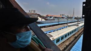 A man wearing a face masks looks at trains parked at New Delhi Railway Station (NDLS) as Indian Railways extend operations during lockdown in New Delhi.(Raj K Raj/HT PHOTO) A man wearing a face masks looks at trains parked at New Delhi Railway Station (NDLS) as Indian Railways extend operations during lockdown in New Delhi.(Raj K Raj/HT PHOTO)
