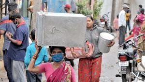 People living near the banks of Krishna River carry household things as they move towards a safer place after flood-like situation in Maharashtra’s Sangli district on Monday.(ANI Photo) People living near the banks of Krishna River carry household things as they move towards a safer place after flood-like situation in Maharashtra’s Sangli district on Monday.(ANI Photo)