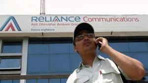 A man talks on a mobile phone in front of an advertisement for Reliance Communications.(Reuters File Photo) A man talks on a mobile phone in front of an advertisement for Reliance Communications.(Reuters File Photo)