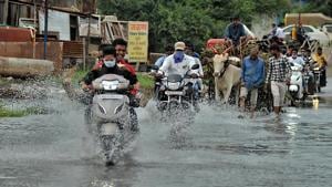 Local people wade submerged bank side area road during Krishna river flooding after heavy rain in catchment area of Koyana dam in Sangli on Tuesday(Uday Deolekar/HT Photo) Local people wade submerged bank side area road during Krishna river flooding after heavy rain in catchment area of Koyana dam in Sangli on Tuesday(Uday Deolekar/HT Photo)