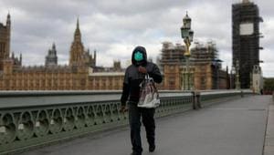 A commuter wearing a protective face mask crosses Westminster Bridge in view of the Houses of Parliament and Elizabeth Tower, also known as Big Ben, in London, UK.(Bloomberg File Photo) A commuter wearing a protective face mask crosses Westminster Bridge in view of the Houses of Parliament and Elizabeth Tower, also known as Big Ben, in London, UK.(Bloomberg File Photo)