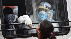 A health worker in PPE coveralls collects a swab sample from a woman to test for Covid-19 infection at Adarsh Nagar in New Delhion Thursday.(Sanchit Khanna/HT File Photo) A health worker in PPE coveralls collects a swab sample from a woman to test for Covid-19 infection at Adarsh Nagar in New Delhion Thursday.(Sanchit Khanna/HT File Photo)