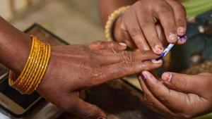 All voters will be given gloves to sign voter register and press EVM button to cast vote(PTI) All voters will be given gloves to sign voter register and press EVM button to cast vote(PTI)