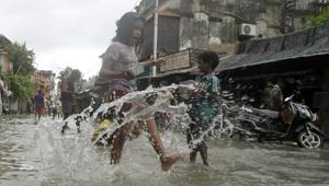 Children wade through flooded street as a street of Kalighat flooded due to heavy rains, in Kolkata on Wednesday.(ANI photo) Children wade through flooded street as a street of Kalighat flooded due to heavy rains, in Kolkata on Wednesday.(ANI photo)
