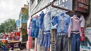 School uniforms hung outside a shop in Gandhi Nagar. School uniform manufacturers and sellers are facing severe losses as schools remain closed due to the Covid pandemic. (Biplov Bhuyan/HT Photo) School uniforms hung outside a shop in Gandhi Nagar. School uniform manufacturers and sellers are facing severe losses as schools remain closed due to the Covid pandemic. (Biplov Bhuyan/HT Photo)