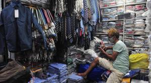 A school dress vendor playing games on his mobile phone to pass time while his shop in Sadar Bazaar in Sector 19 wears a deserted look in Chandigarh.(Ravi Kumar/HT) A school dress vendor playing games on his mobile phone to pass time while his shop in Sadar Bazaar in Sector 19 wears a deserted look in Chandigarh.(Ravi Kumar/HT)