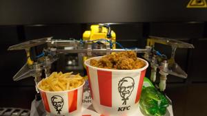 A robotic arm lifts an order of food from a conveyor belt inside a new contactless Kentucky Fried Chicken (KFC) restaurant, operated by Yum! Brands Inc., ahead of its official opening in Moscow, Russia.(Bloomberg) A robotic arm lifts an order of food from a conveyor belt inside a new contactless Kentucky Fried Chicken (KFC) restaurant, operated by Yum! Brands Inc., ahead of its official opening in Moscow, Russia.(Bloomberg)