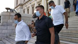 Manchester United player Harry Maguire's father, Alan, background leaves a court building with two other men after his son was found guilty of assault and attempting to bribe a police officer, on the Aegean island of Syros, Greece, Tuesday, Aug. 25, 2020. Maguire has been found guilty of assault at a trial and handed a 21-month suspended sentence following his arrest after a brawl last week on the island of Mykonos, court officials in Greece said. (Giorgos Solaris/InTime News via AP)(AP) Manchester United player Harry Maguire's father, Alan, background leaves a court building with two other men after his son was found guilty of assault and attempting to bribe a police officer, on the Aegean island of Syros, Greece, Tuesday, Aug. 25, 2020. Maguire has been found guilty of assault at a trial and handed a 21-month suspended sentence following his arrest after a brawl last week on the island of Mykonos, court officials in Greece said. (Giorgos Solaris/InTime News via AP)(AP)