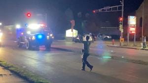 A man with a firearm raises his hands up as he walks towards vehicles during a protest following the police shooting of Jacob Blake, a Black man, in Kenosha, Wisconsin.(Reuters) A man with a firearm raises his hands up as he walks towards vehicles during a protest following the police shooting of Jacob Blake, a Black man, in Kenosha, Wisconsin.(Reuters)