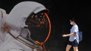 A woman wearing a face mask walks past a mural, following the coronavirus disease outbreak, in Hong Kong, China.(REUTERS) A woman wearing a face mask walks past a mural, following the coronavirus disease outbreak, in Hong Kong, China.(REUTERS)