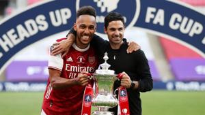 FILE PHOTO: Soccer Football - FA Cup Final - Arsenal v Chelsea - Wembley Stadium, London, Britain - August 1, 2020 Arsenal manager Mikel Arteta and Pierre-Emerick Aubameyang celebrate with the trophy after winning the FA Cup, as play resumes behind closed doors following the outbreak of the coronavirus disease (COVID-19) Pool via REUTERS/Catherine Ivill(Pool via REUTERS) FILE PHOTO: Soccer Football - FA Cup Final - Arsenal v Chelsea - Wembley Stadium, London, Britain - August 1, 2020 Arsenal manager Mikel Arteta and Pierre-Emerick Aubameyang celebrate with the trophy after winning the FA Cup, as play resumes behind closed doors following the outbreak of the coronavirus disease (COVID-19) Pool via REUTERS/Catherine Ivill(Pool via REUTERS)