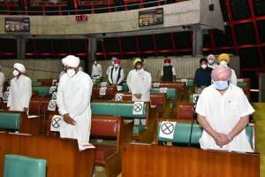 Chief minister Captain Amarinder Singh and finance minister Manpreet Singh Badal while the obituary references were being made in the Punjab assembly on Friday. Social distancing was maintained as the members met amid the Covid-19 pandemic.(Ravi Kumar/HT Photo)