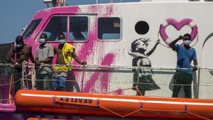 A boy waves to the crew of the Astral rescue vessel from the deck of the Louise Michel rescue vessel, a French patrol boat currently manned by activists and funded by the renowned artist Banksy in the Central Mediterranean sea, at 50 miles south from Lampedusa, Friday, Aug. 28, 2020. A Berlin-based group says it has begun migrant rescue operations in the Mediterranean Sea with a bright pink former navy vessel sponsored by British artist Banksy. The group operating the MV Louise Michel, a sleek 30-meter (98-foot) ship named after a 19th century French feminist and anarchist, said late Thursday that it rescued 89 from an inflatable boat in distress.(AP) A boy waves to the crew of the Astral rescue vessel from the deck of the Louise Michel rescue vessel, a French patrol boat currently manned by activists and funded by the renowned artist Banksy in the Central Mediterranean sea, at 50 miles south from Lampedusa, Friday, Aug. 28, 2020. A Berlin-based group says it has begun migrant rescue operations in the Mediterranean Sea with a bright pink former navy vessel sponsored by British artist Banksy. The group operating the MV Louise Michel, a sleek 30-meter (98-foot) ship named after a 19th century French feminist and anarchist, said late Thursday that it rescued 89 from an inflatable boat in distress.(AP)